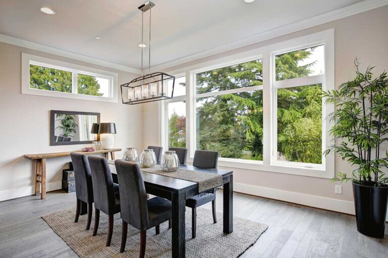 A home inspector reviews notes inside a residential living room, with tools and a clipboard in hand.